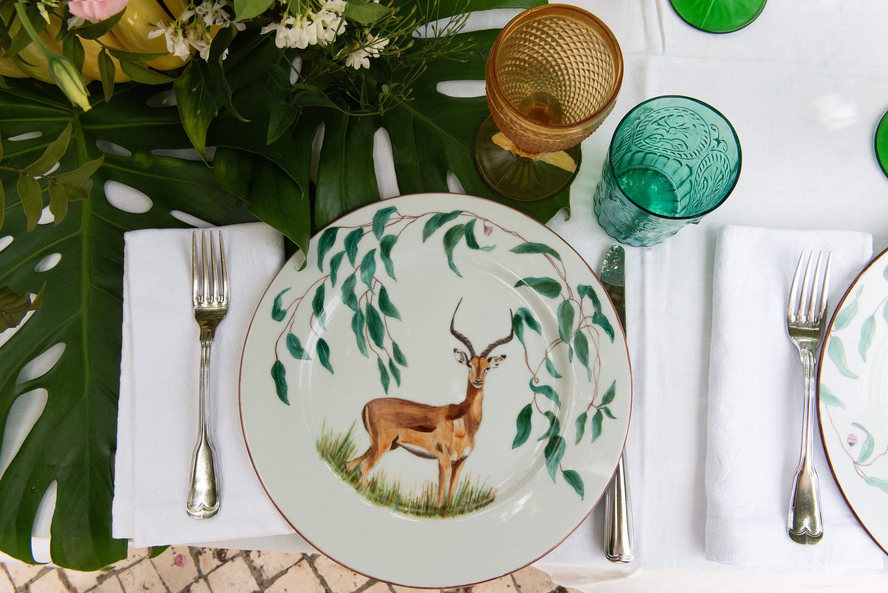 EVM Porcelain lifestyle mood image "Taste of Africa" entire plates showing an Antelope, set up on a table with decoration and cutlery