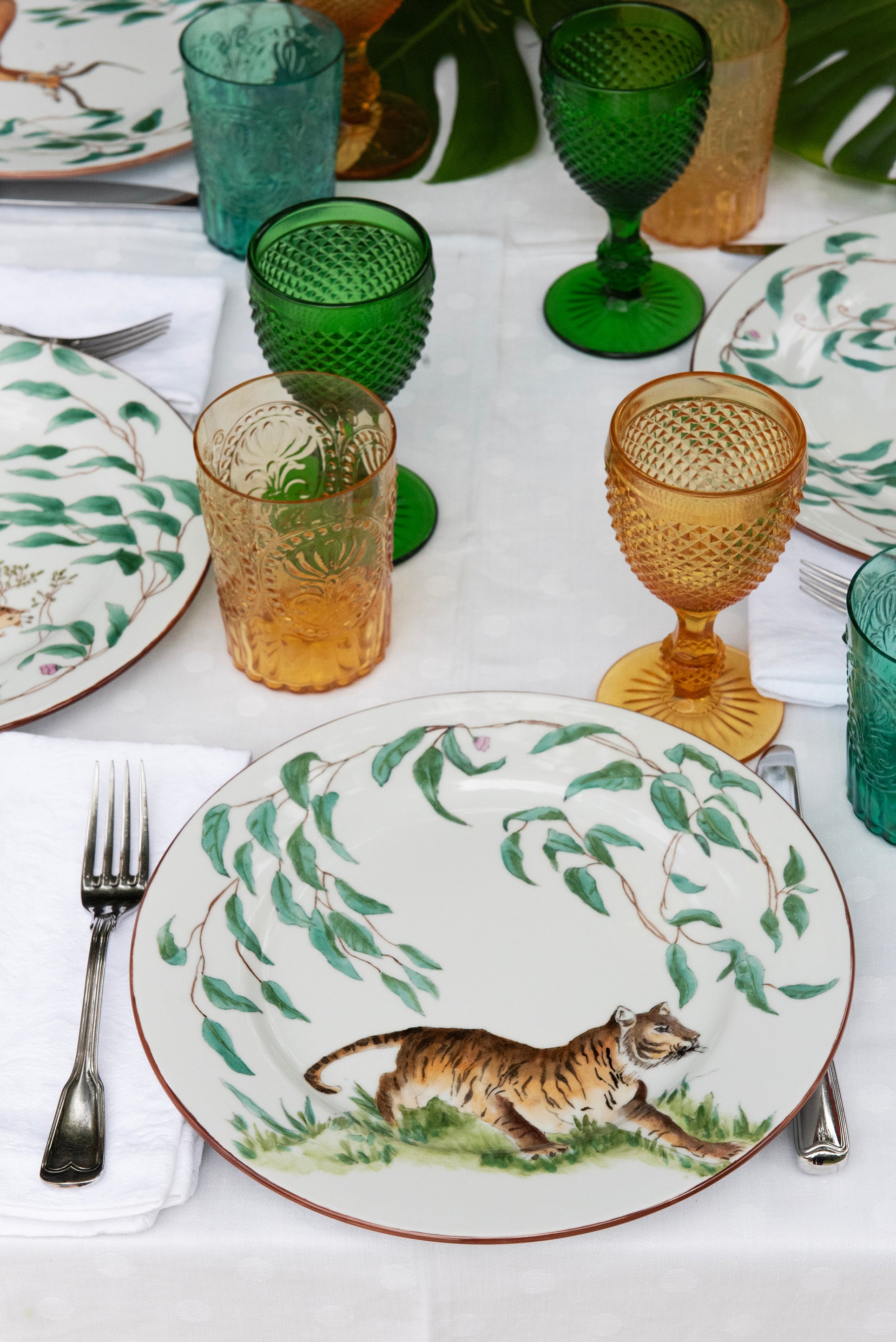 EVM Porcelain lifestyle mood image "Taste of Africa" entire plate showing a Tiger, set up on a table with plants, colourful glasses and cutlery